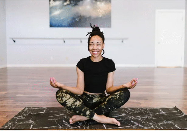 A Woman On A Yoga Mat Doing Yoga